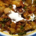 close up picture of potato casserole with bacon, cheese and sour cream