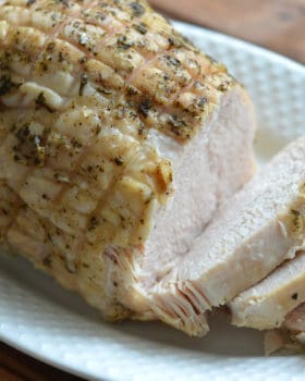 cooked turkey breast sliced on a plate