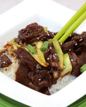 honey hoisin beef on rice in a bowl with chopsticks