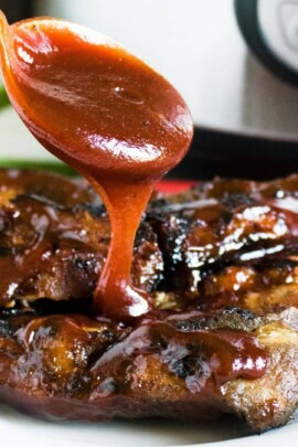 BBQ sauce being drizzled on rib tips
