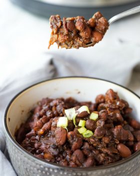baked beans and bacon in a blue bowl