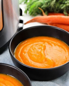 instant pot carrot soup in a black bowl