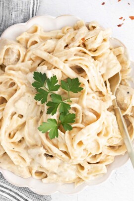 close up of chicken alfredo with a silver fork