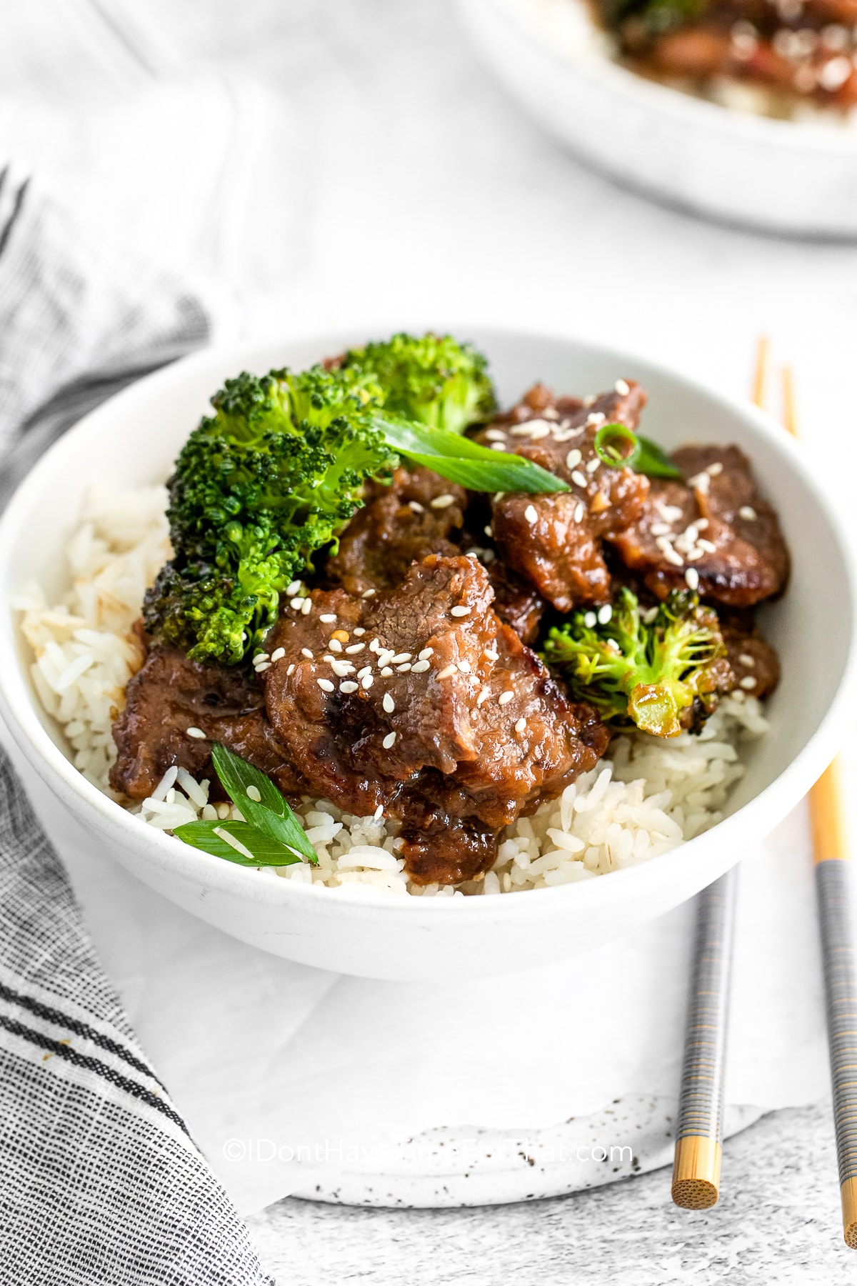 mongolian beef in a bowl with sesame seeds