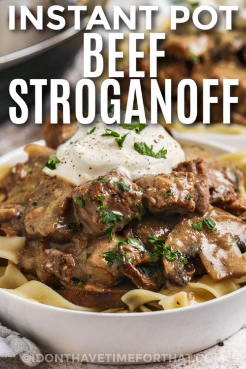 plated Instant Pot Beef Stroganoff with sour cream and writing