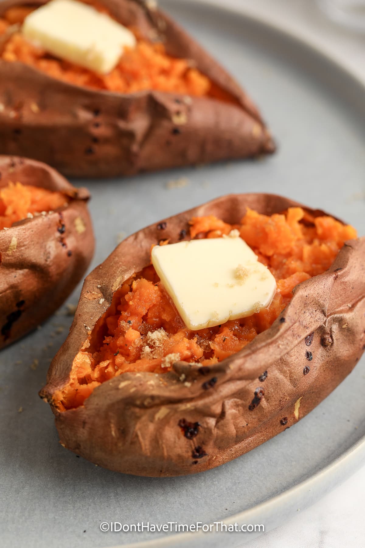 Air Fryer brown sugar sweet potatoes with butter on a serving plate