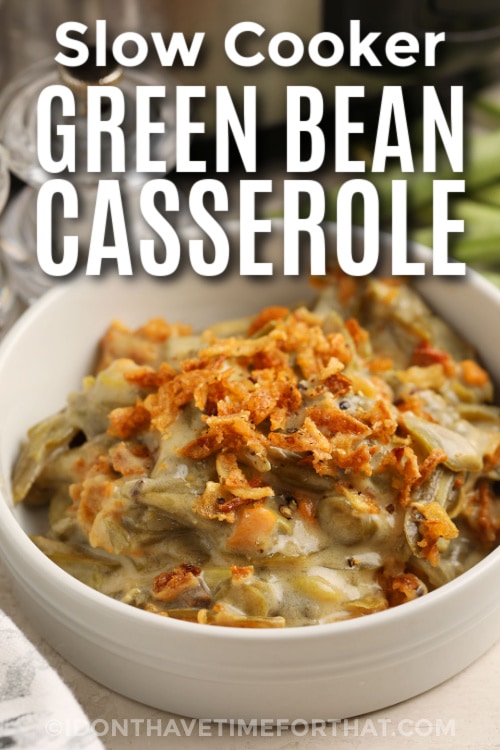 Close up of green bean casserole in white bowl with writing