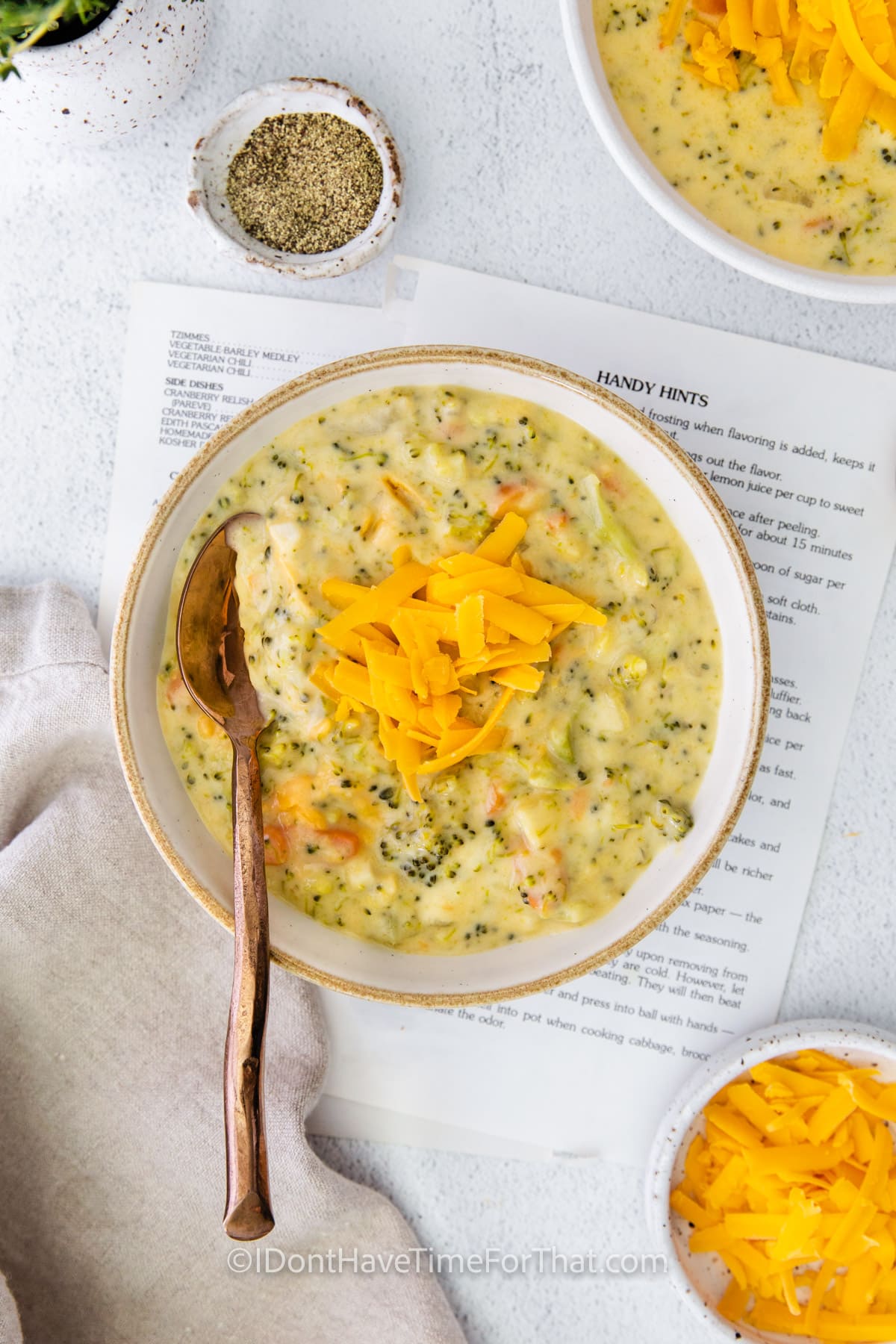 Instant Pot Broccoli Cheddar Soup in a bowl with.a spoon