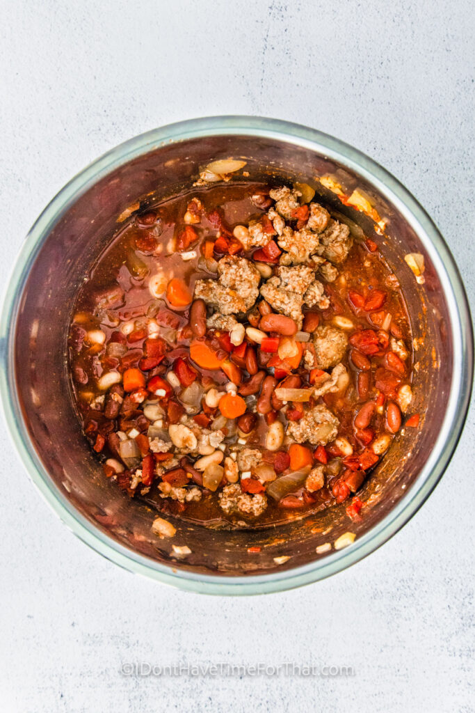 adding beans to pot to make Instant Pot Turkey Chili