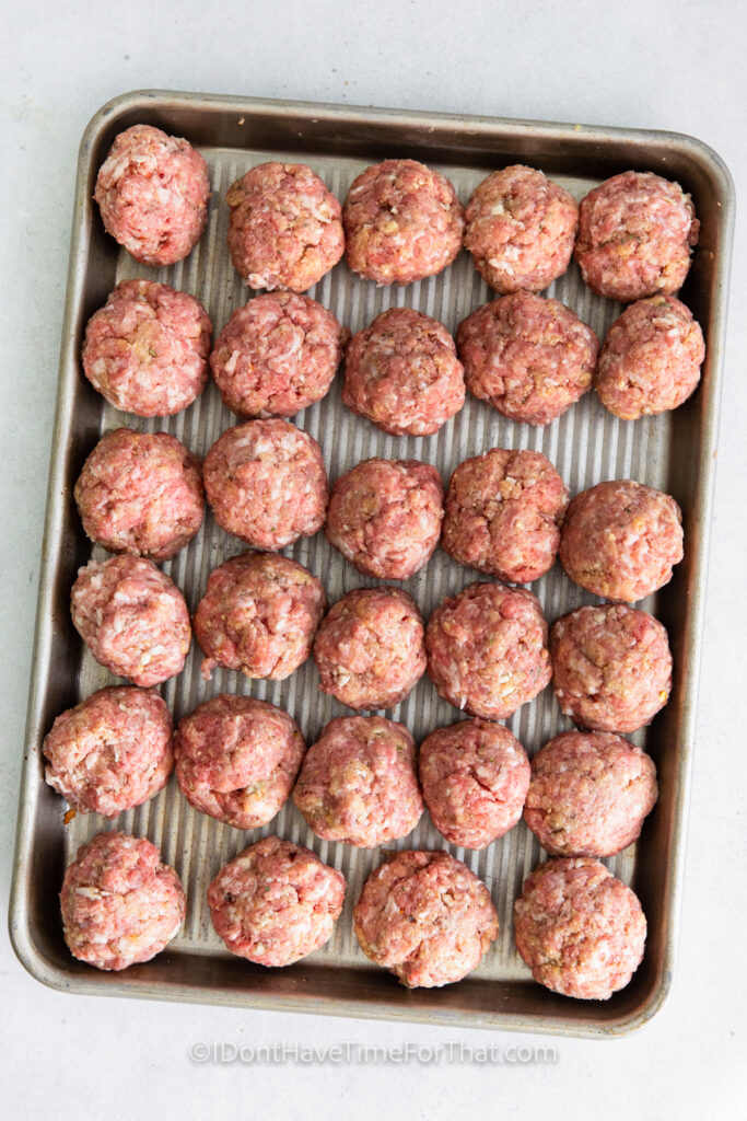 shaping Air Fryer Meatballs into balls and putting on a sheet pan
