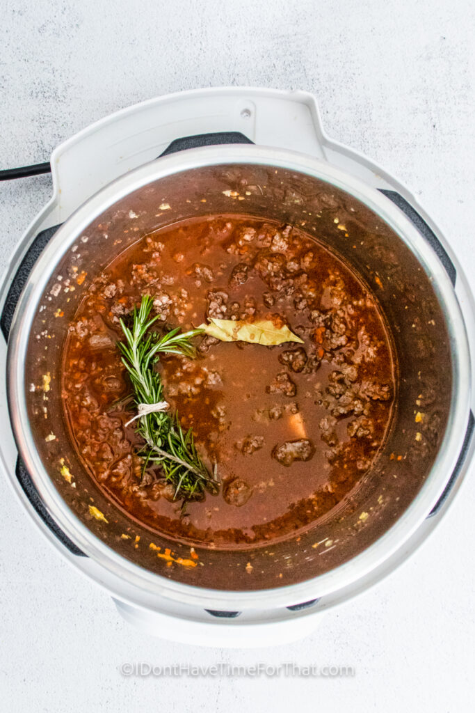 adding ingredients to instant pot to make Instant Pot Bolognese