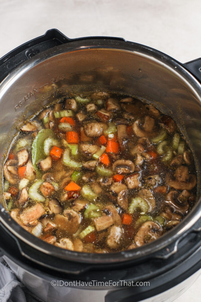 adding broth to pot to make Mushroom Wild Soup