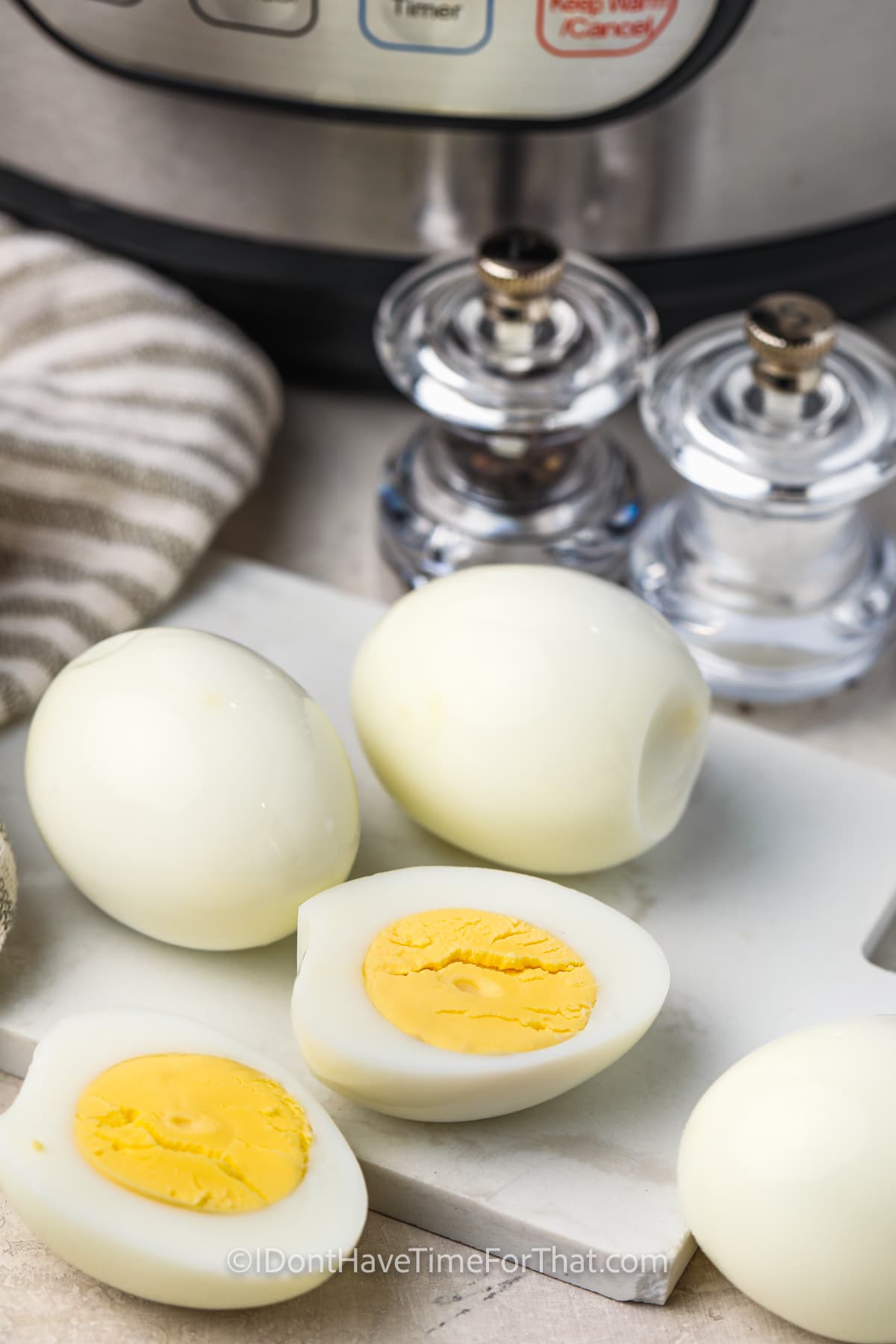 slicing Hard Boiled Eggs in Instant Pot on a cutting board