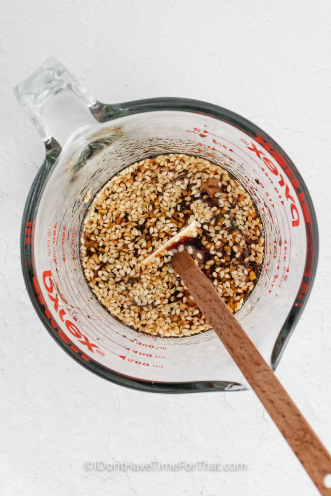 mixing sesame seeds with soy sauce to make Instant Pot Sesame Chicken Bowls