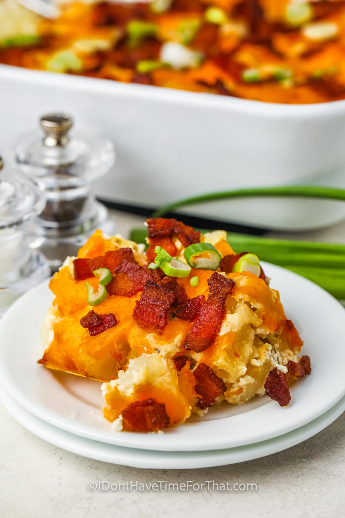 plated Loaded Potato Casserole with dish full in the back