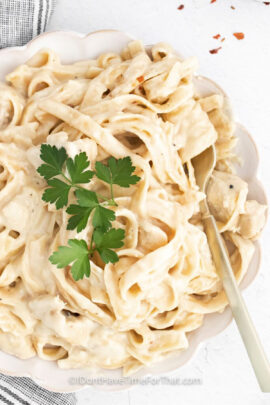 plated Instant Pot Chicken Alfredo with a fork