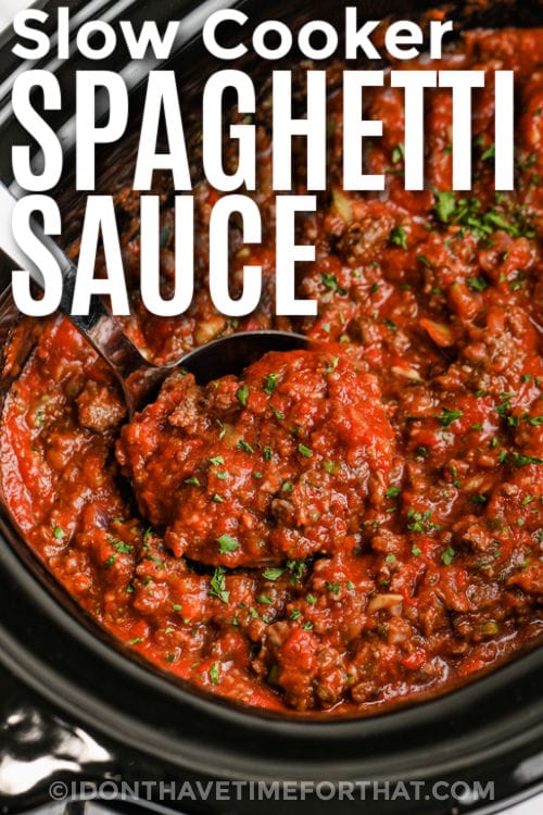 taking a spoonful of Slow Cooker Spaghetti Sauce out of the pot with a title