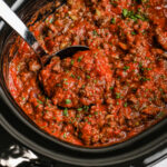 cooked Slow Cooker Spaghetti Sauce with a spoon