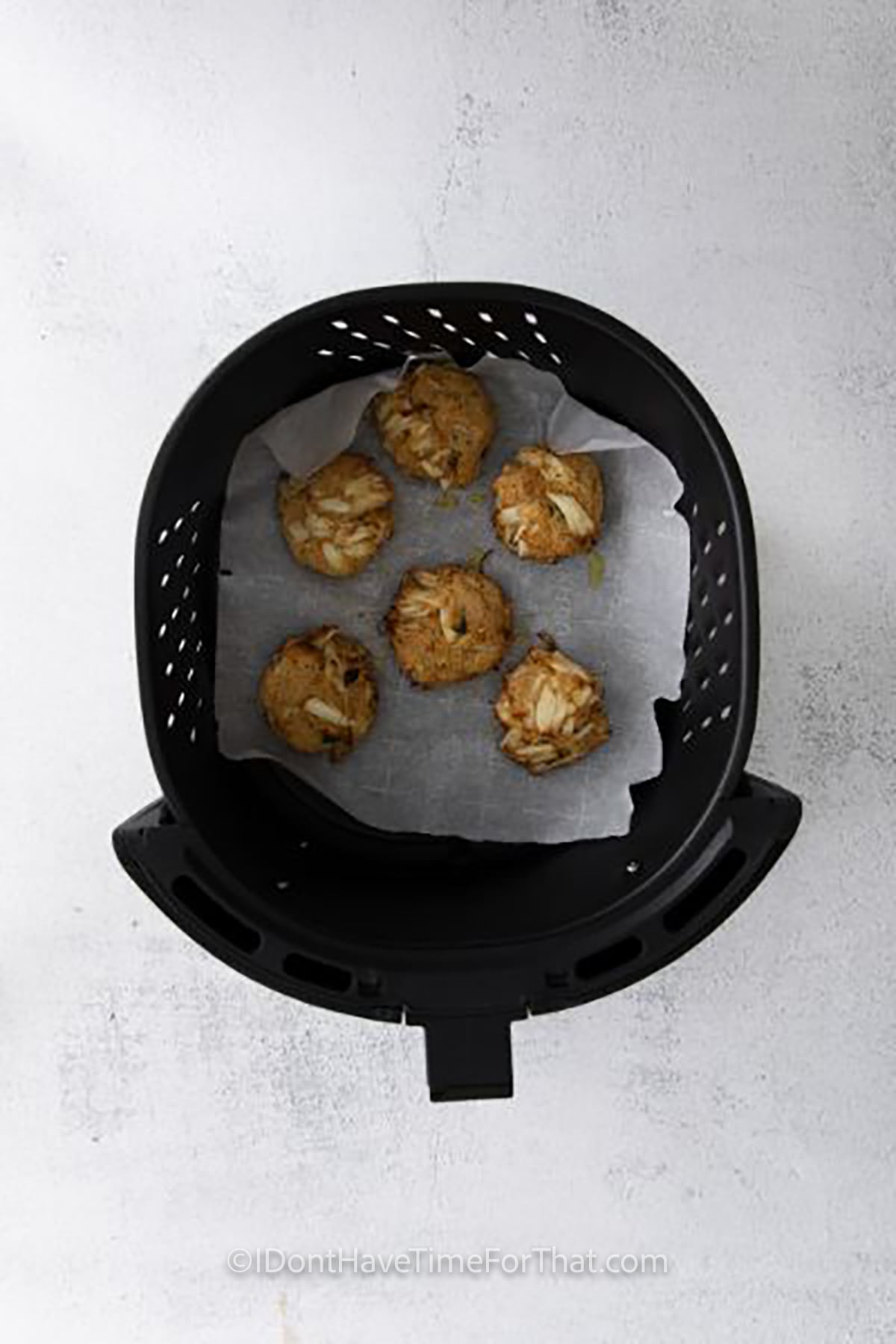 Air Fryer Crab Cakes cooking in the fryer