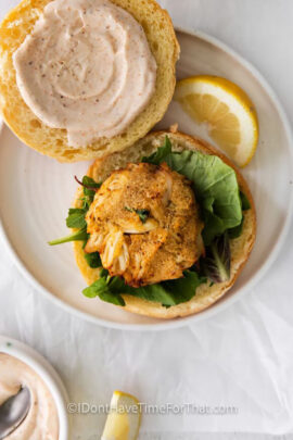 plated Air Fryer Crab Cake on a dressed bun with lemon wedge