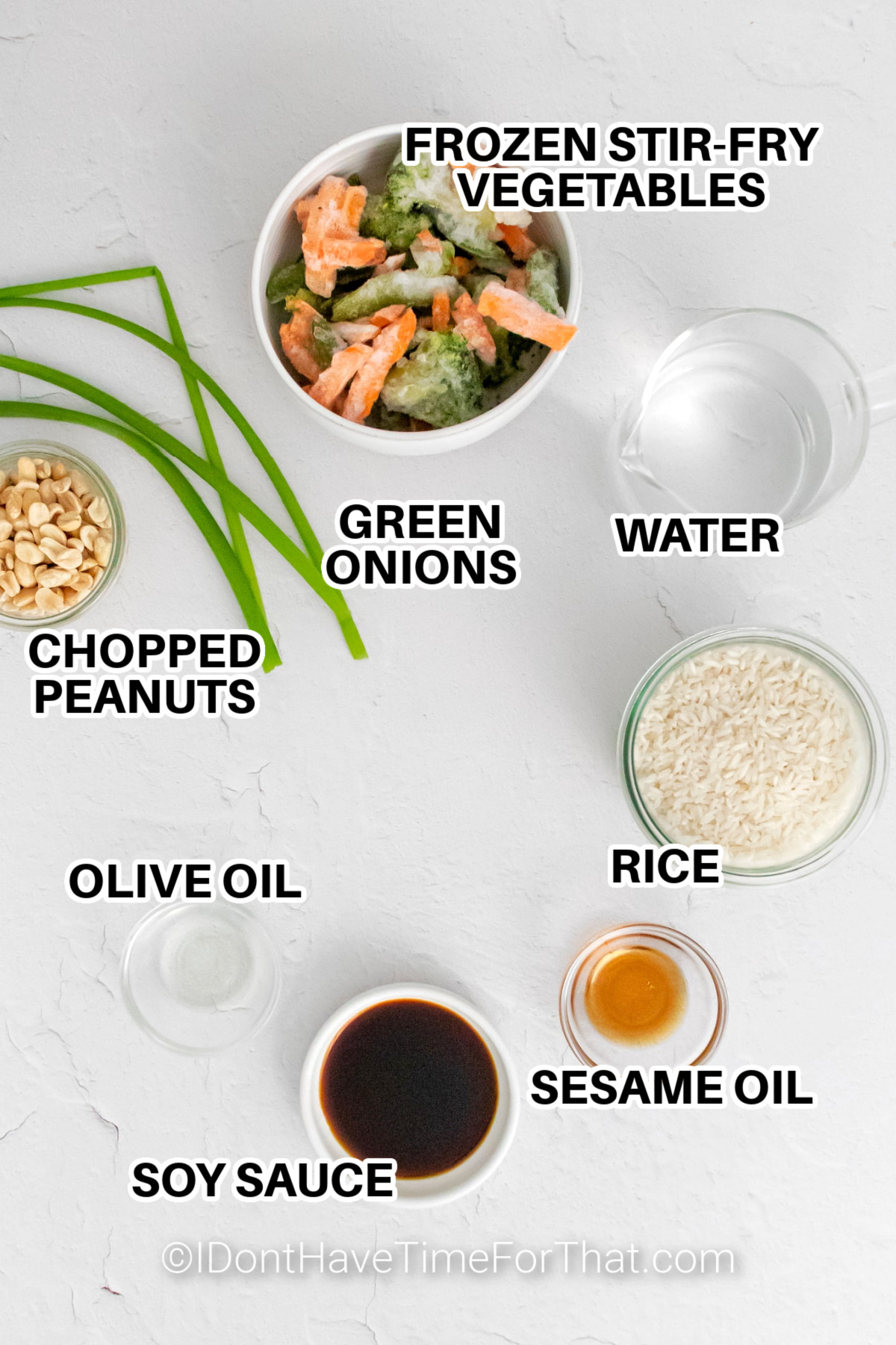 Ingredients to make instant pot vegetable fried rice labeled: frozen stir-fry vegetables, water, rice, sesame oil, soy sauce, olive oil, chopped peanuts, and green onions